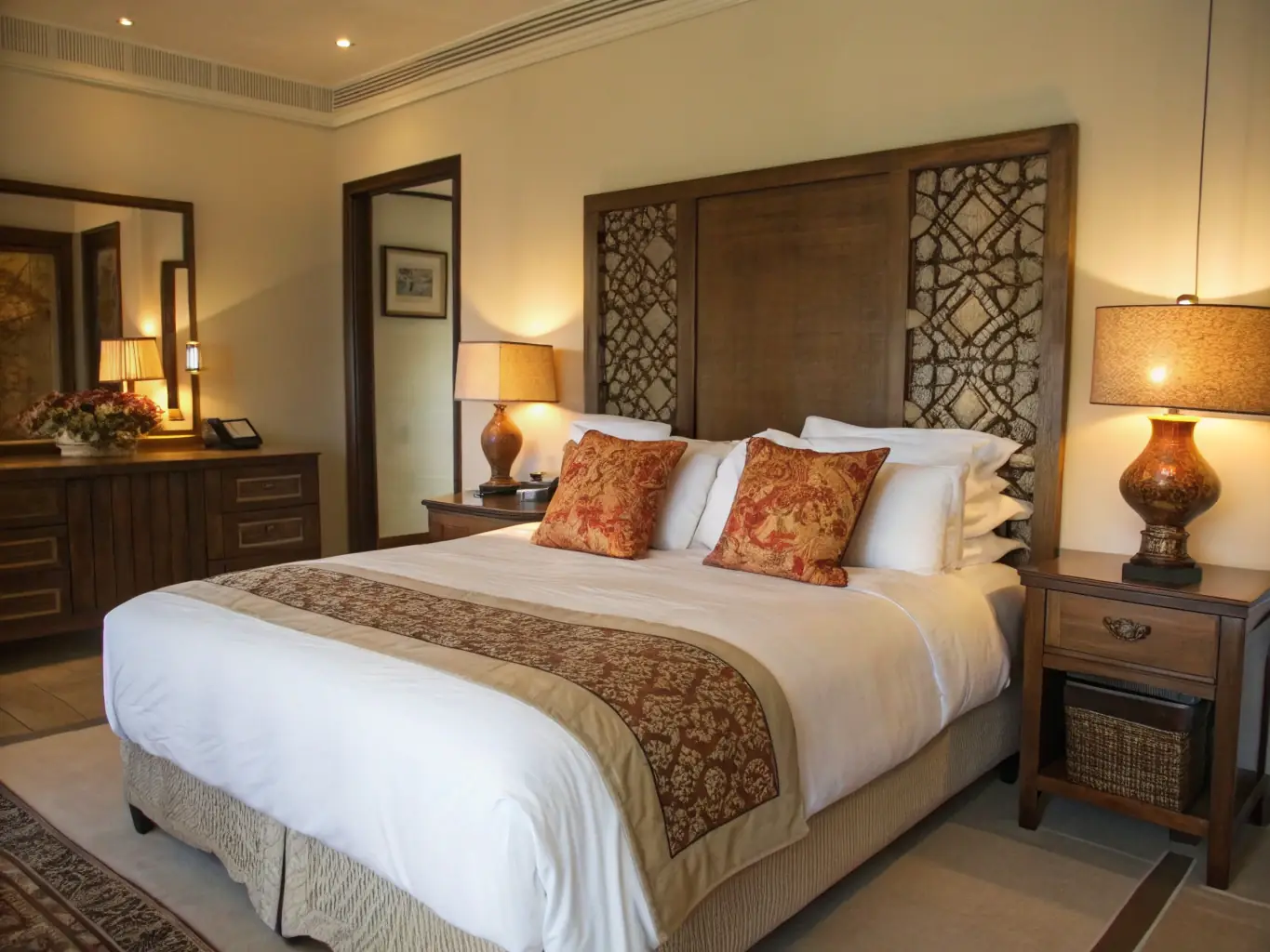 A beautifully styled photograph of the principal bedroom at Palmstone Farmhouse, showcasing the king-size bed, fireplace, and high ceilings. The image should convey a sense of luxury and comfort.